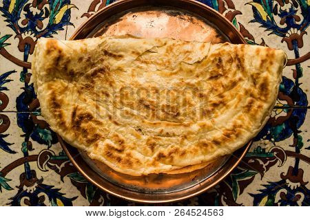 Turkish Bread Katmer On A Ottoman Pattern Surface.