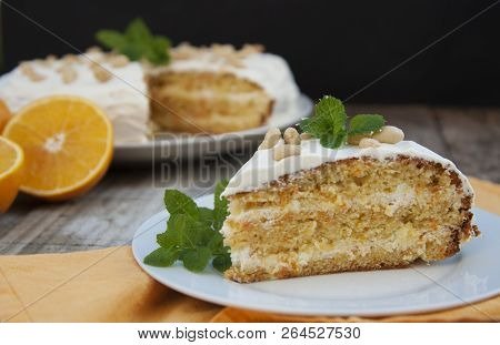 Orange And Carrotn Cake, Wooden Background. Rustic Style.