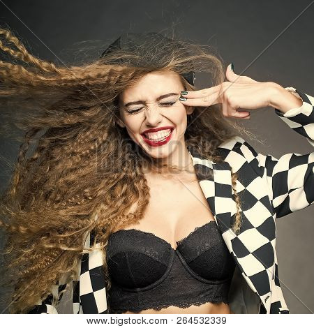 Portrait Of Attractive Woman With Fly-away Wavy Long Hair Wearing Black And White Cardigan Cap Under