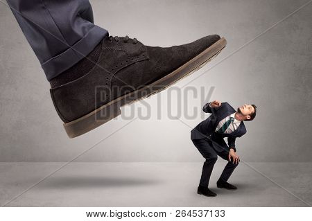 Young businessman illustrated inconsiderable by being trampled
