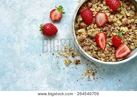 Multicereal Homemade Organic Granola Served With Fresh Strawberry, Nuts, Honey, Milk And Yogurt.top