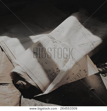 Old Paper Skatches On The Ground In The Shadow