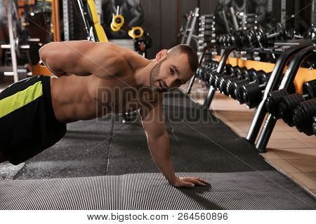 Strong Man Doing Single-arm Plank Exercise In Gym