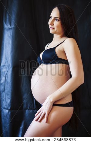 Young Pregnant Woman With Long Hair On Black Background, Lifesty