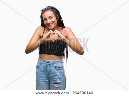 Young braided hair african american with pigmentation blemish birth mark over isolated background smiling in love showing heart symbol and shape with hands. Romantic concept.