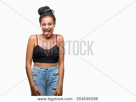 Young braided hair african american with pigmentation blemish birth mark over isolated background sticking tongue out happy with funny expression. Emotion concept.