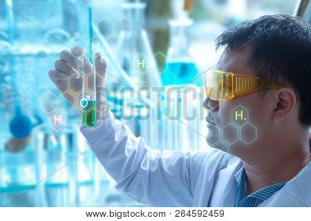 Medical Research Scientists Look With A Tube Of Sample In A The Forensic Laboratory