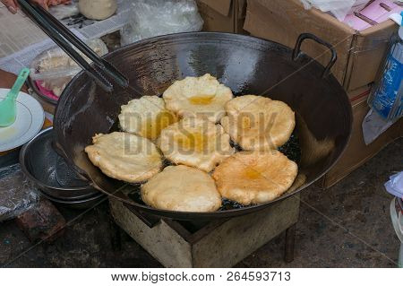 Traditional Vietnamese Pastry Pancakes Deep Fried In Oil. Street Food Cooking