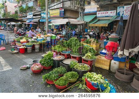 Ho Chi Minh City, Vietnam - August 25, 2017: Cho Xom Chieu Fresh Produce Market Vendors Selling Gree