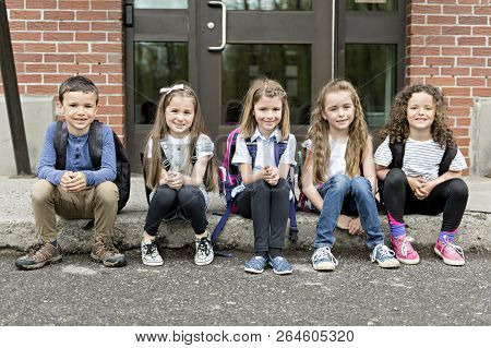 A Group Of Students Outside At School Standing Together