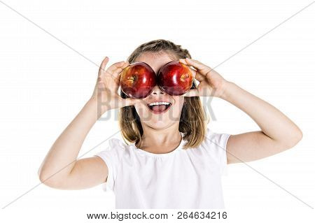 Portrait Of A Cute 7 Years Old Girl Isolated Over White Background With Apple
