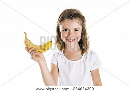 Portrait Of A Cute 7 Years Old Girl Isolated Over White Background With Banana