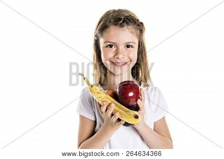 Portrait Of A Cute 7 Years Old Girl Isolated Over White Background With Apple, Banana And Avocado