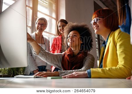 women designers having fun while working together on joint project