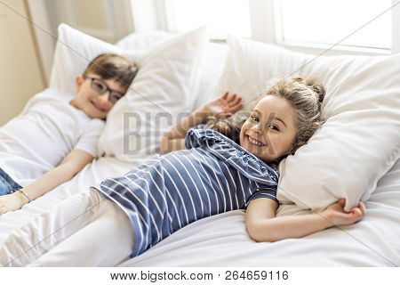 Brother And Sister Having Fun Together On Bed