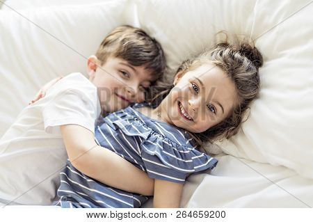 Brother And Sister Having Fun Together On Bed