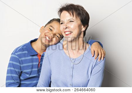 Black Boy With Grandmother In Studio White Background