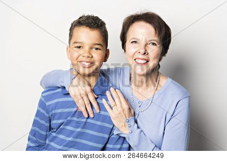 Black Boy With Grandmother In Studio White Background
