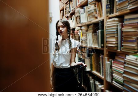 Girl With Pigtails In White Blouse At Old Library.