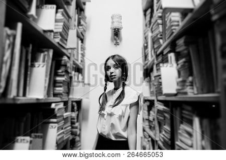 Girl With Pigtails In White Blouse At Old Library.