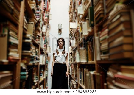 Girl With Pigtails In White Blouse At Old Library.