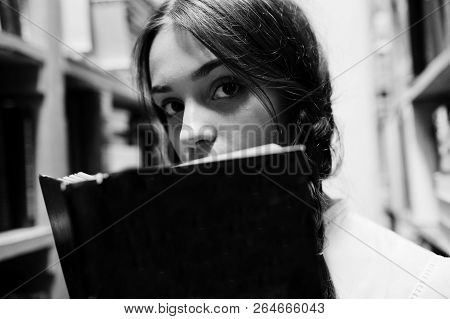 Girl With Pigtails In White Blouse At Old Library.