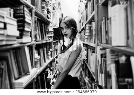 Girl With Pigtails In White Blouse At Old Library.