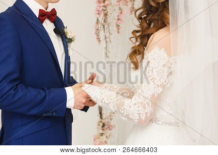 Wedding Day. Ceremony. Wedding Hands With Rings. The Bride And Groom Hold Hands. Close Up