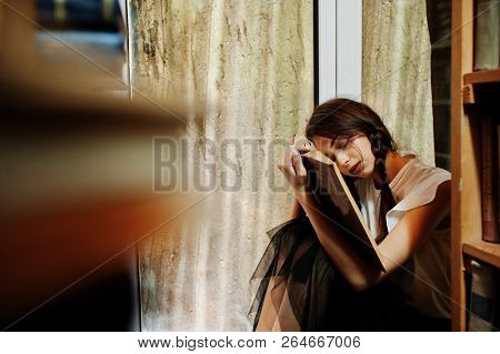 Girl With Pigtails In White Blouse At Old Library.