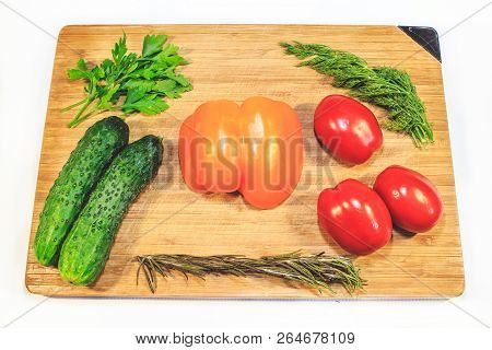 Vegetables Cucumbers Tomatoes Sweet Pepper Parsley Dill On A Wooden Board