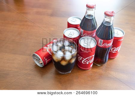 Bangkok, Thailand - October 23, 2018: Coca-cola With Ice In Glass And Can,bottle Of Coca-cola On Woo