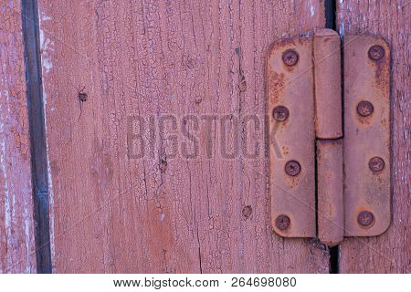 Red Old Weathered Worn Rustic Wooden Boards With Rusty Metal Door Hinge. Background