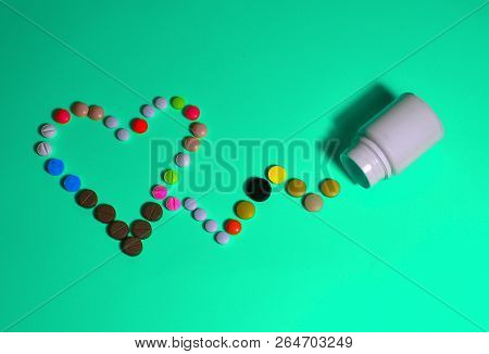 Assorted Pharmaceutical Medicine Pills, Tablets And Capsules And Bottle On Blue Background. Space Fo