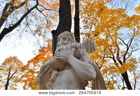 The God Saturn Statue In Summer Garden At Autumn Evening, St.petersburg, Russia.