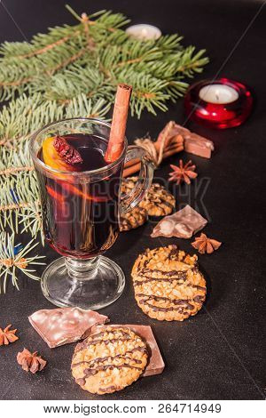 A Glass Of Flavored Mulled Wine On A Black Leather Background With Biscuits Pieces Of Chocolate Chop
