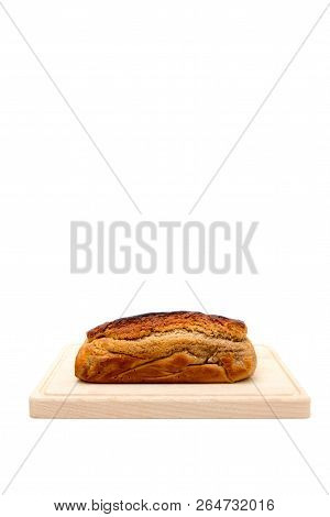 A Homemade Plumcake Standing On A Wooden Board With A White Background