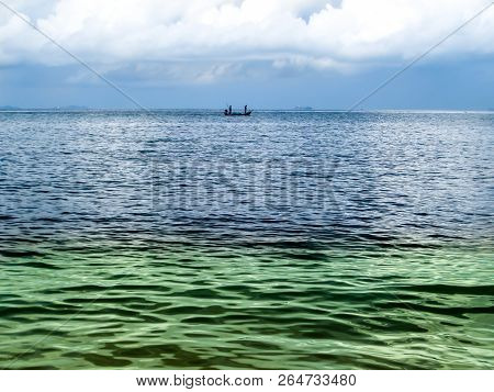 Fishing Boat And Two Color Sea