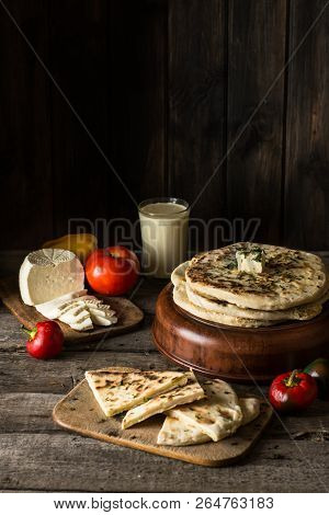 Pita Bread On Wooden Board With Feta Cheese And Tomatoes And Pepper. Still Life Of Food. Georgian Cu