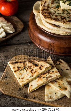 Pita Bread On Wooden Board With Feta Cheese And Tomatoes And Pepper. Still Life Of Food. Georgian Cu