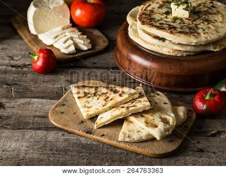 Pita Bread On Wooden Board With Feta Cheese And Tomatoes And Pepper. Still Life Of Food. Georgian Cu