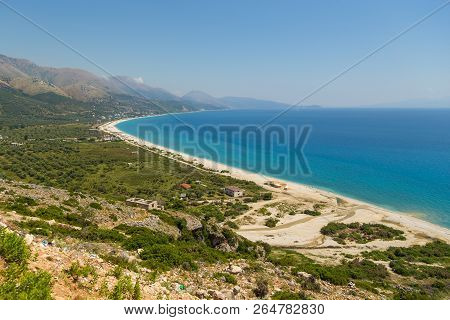 View On The Borsh Beach In Albania. Stony Beach On The Adriatic Sea. Mountain In The Background.