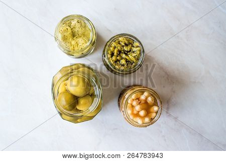 Jars Of Pickled Vegetables Green And White Asparagus, Artichoke Heart And Unripe Green Almond Pickle