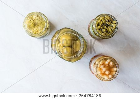 Jars Of Pickled Vegetables Green And White Asparagus, Artichoke Heart And Unripe Green Almond Pickle