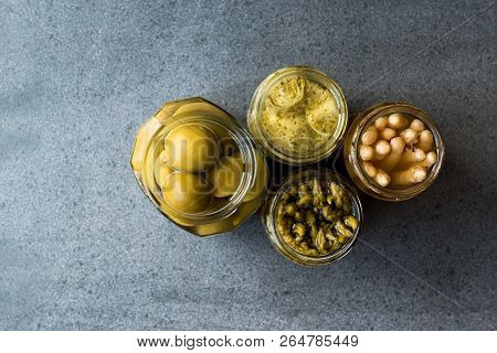 Jars Of Pickled Vegetables Green And White Asparagus, Artichoke Heart And Unripe Green Almond Pickle