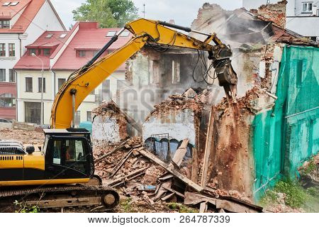 excavator crasher machine at demolition on construction site