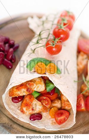 Delicious mexican wrap with chicken stripes and vegetable