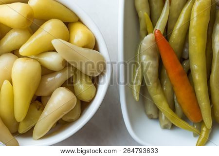 Pickled Green Pepper Pickles In Bowls. Traditional Organic Food.