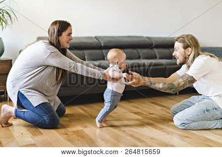 Parent Help Baby Daughter Take First Steps At Home