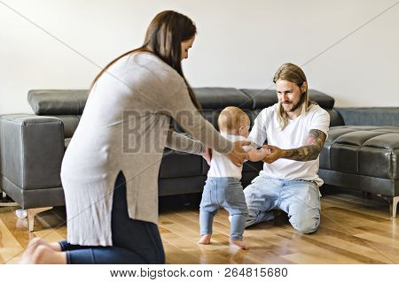 Parent Help Baby Daughter Take First Steps At Home