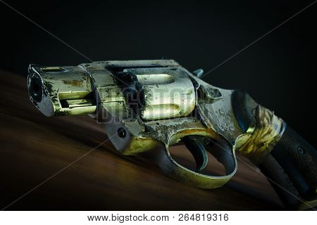Post Apocalyptic Pistol On Wood Surface With Dark Background